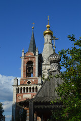 The dome of the white-stone tent Church of the 16th century, the bell tower in the Gothic style of the 18th century and the wooden chapel, the Church of the Transfiguration of the Lord in the village 