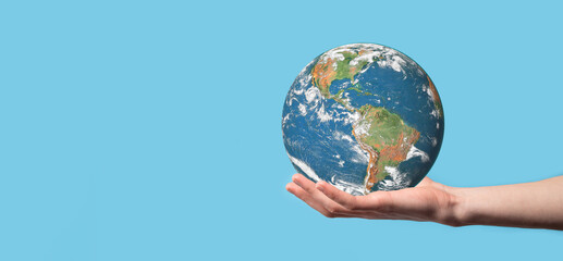 3D Earth planet globe in man, woman hand, hands on blue background. Environmental protection concept. Elements of this image furnished by NASA