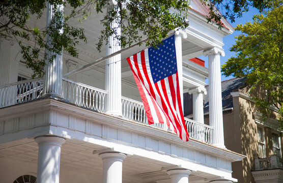 Southern historic home flying American flag in Charleston, South Carolina, USA.