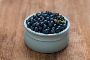 Blueberries on rustic rown wooden board background. Healthy eating