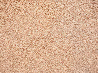 Close up painted golden concrete wall stucco texture background pattern, exterior outside house appartment living room decoration. Empty free copy space for text or message. 
