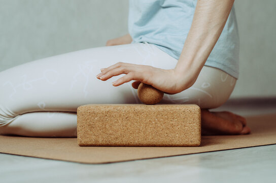 Side view of person doing palmar fascia release with a small cork ball on a cork block 