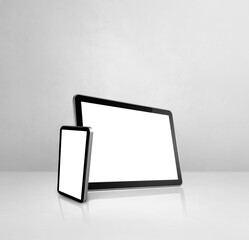 Mobile phone and digital tablet pc on white concrete office desk