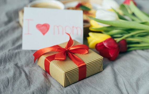 Close-up of gift present box for Mother's day. Festive brunch or breakfast. Good morning concept