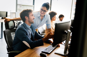 Programmers cooperating at IT company developing apps