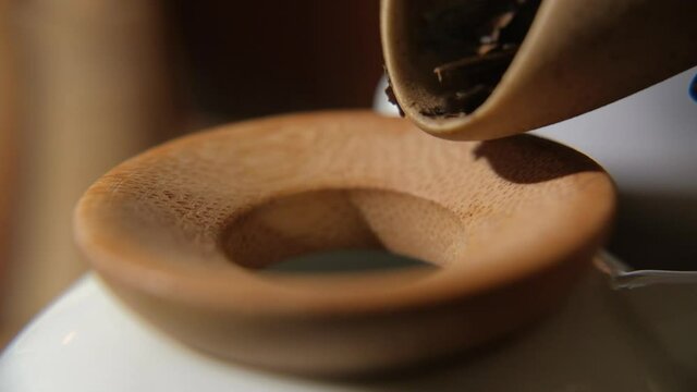 The tea master pours tea from the chahe into the teapot. Slow motion close-up, macro shot. Traditional Chinese tea drinking ceremony. Chinese Japanese tea, Puer Shu Gong Ting Xiao Tocha Oolong Zhang