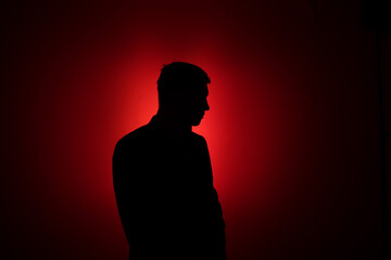 Silhouette of a man on a red background.