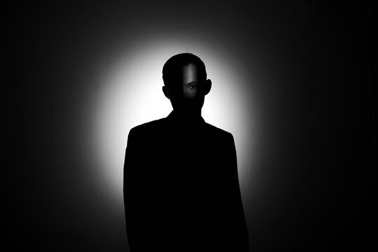 silhouette of a man in the dark.