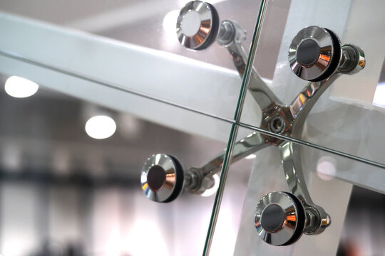Architecture abstract background. Glass curtain walls. Fasteners elements of spider glass system. Facade detail
