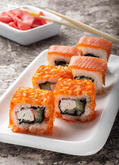 Salmon rolls on a dark background. Salmon and ginger rolls