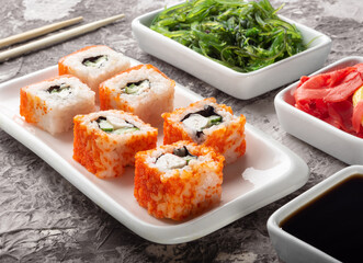 Salmon rolls on a dark background. Salmon and ginger rolls