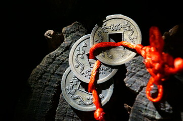 Metal Feng Shui coin on a wooden background.