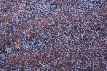 Wooden surface covered with snowflakes.