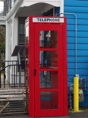 The red telephone booth near the cafe.