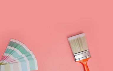 Paintbrush with palette for painting sample with pastel colors on pink background top view, Flat...