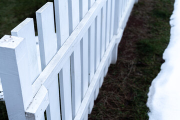 Beautiful white garden fence made of wood close up