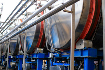 Large stainless steel food containers in a beverage or wine factory