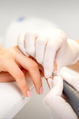 Manicurist removing old nail polish