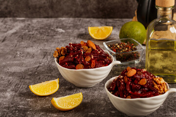 Beetroot Salad with raisins nuts and lemon on a dark gray background. Close-up.  Healthy eating, vegetarian food.