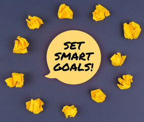 Among the crumpled pieces of paper lies a sticker sheet with the inscription - SET SMART GOALS