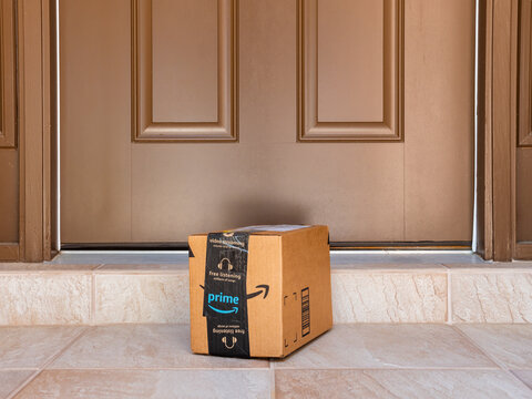 NORTH PORT, FLORIDA - MARCH 16, 2021: Amazon Prime Box Delivered To Residential Doorstep. Amazon Offers Free Package Delivery To It's Prime Members.