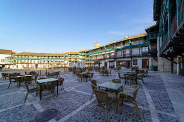 Central square of the town of Chinchon in Madrid, typical houses with wooden balconies and an old medieval atmosphere.