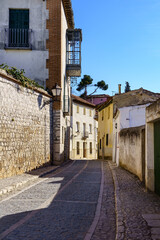 Typical narrow streets of the medieval town of Chinchón in Madrid, houses and old architecture in a quiet and relaxing environment.