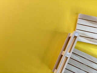 Wooden pallets are lying on a yellow background © Józef