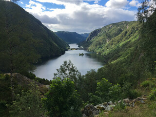 Beautiful ladscape on the mountain lake surrounded by mountains. Snow on the mountains. Huge lake in Norway. Scandinavia.