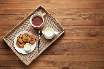 Tray with tasty breakfast on wooden background