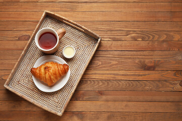Tray with tasty breakfast on wooden background