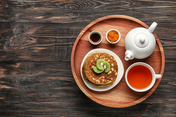 Obraz na płótnie Canvas Tray with tasty breakfast on wooden background
