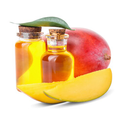 Bottles of essential oil and fresh mango on white background