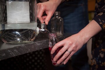 A man prepares a homemade alcoholic drink, close-up.