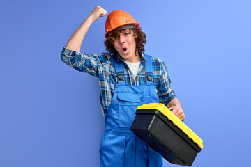 Building sector and industrial workers concept. young male engineer in overalls knocking on helmet