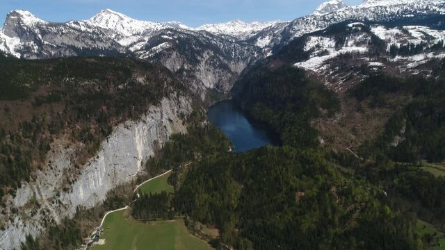 Flight over Toplitz lake in austrian Alps. Easiley snow-caped mountains and beautiful blue lake among them. Kammersee mountain lakes, in Salzkammergut, Styria, Austria. 4K video.