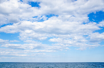 Fototapeta na wymiar Seascape background blue sky with clouds