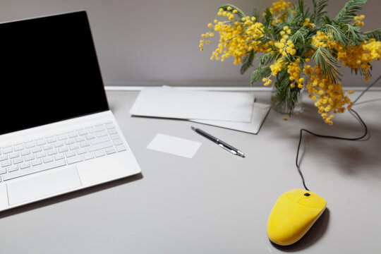 Yellow Computer Mouse And Mimosa On Gray Table