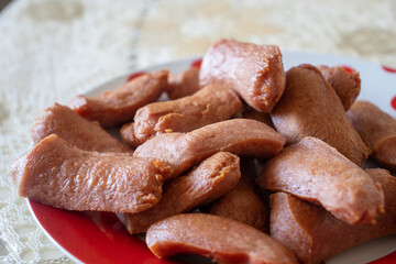 wooden Plate with hot sausages. Fried sausages on a plate.