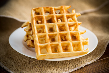 sweet cooked aromatic Belgian waffles in a plate