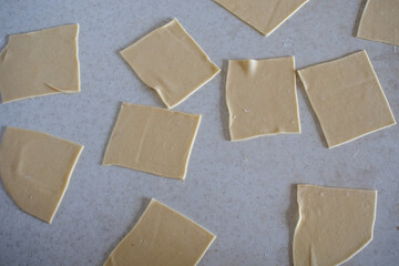 Fototapeta premium Dough cutted into circles. Preparation Meat Dumplings. Cut dough for dumplings