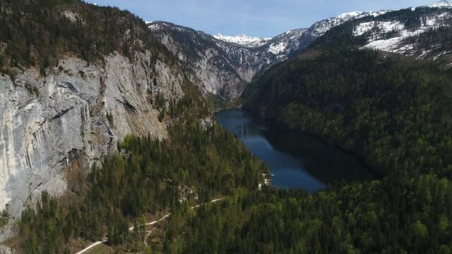 Flight over Toplitz lake in austrian Alps. Easiley snow-caped mountains and beautiful blue lake among them. Kammersee mountain lakes, in Salzkammergut, Styria, Austria. 4K video.