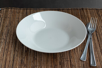 Empty white plate on a table