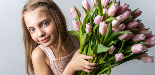 Banner with little beautiful girl holding bunch of pink tulips in hands. Bouquet, congratulations to the holiday of mother, valentine's. International Women's Day, 8 March.Spring,summer time concept