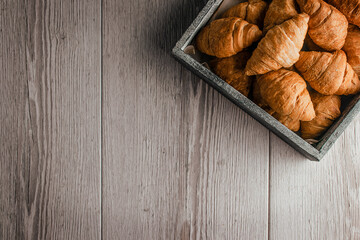 Fresh croissants on a wooden background. Bakery. Morning. Snack. Breakfast. Homemade baking. Croissant french breakfast