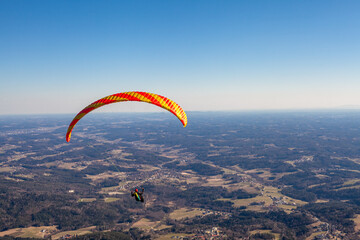 sports paragliding on a parachute over the countryside