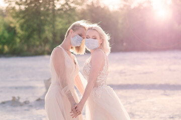 Fototapeta na wymiar Lesbian couple wedding, wear masks to prevent epidemic COVID-19