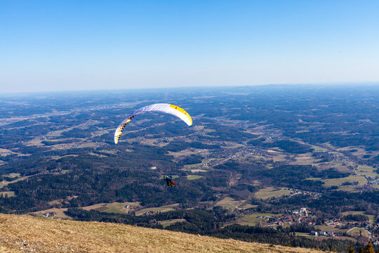 sports paragliding on a parachute over the countryside - Powered by Adobe