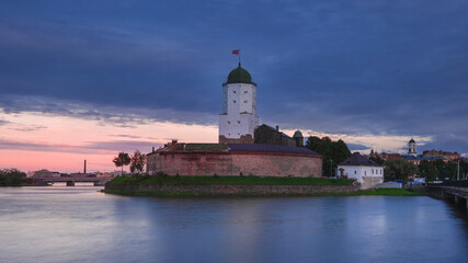 Fototapeta na wymiar Ancient stone castle on the Island in Vyborg at summer sunset