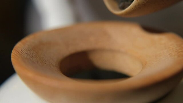 The tea master pours tea from the chahe into the teapot. Slow motion close-up, macro shot. Traditional Chinese tea drinking ceremony. Chinese Japanese tea, Puer Shu Gong Ting Xiao Tocha Oolong Zhang